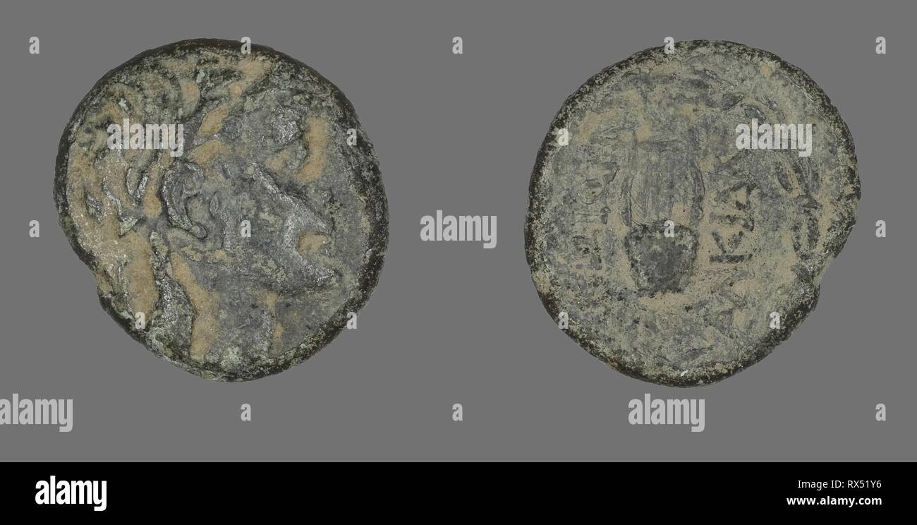 Coin Depicting the God Apollo. Greek. Date: 88 BC-50 BC. Dimensions: Diam. 2.4 cm; 7.67 g. Bronze. Origin: Ancient Greece. Museum: The Chicago Art Institute. Stock Photo