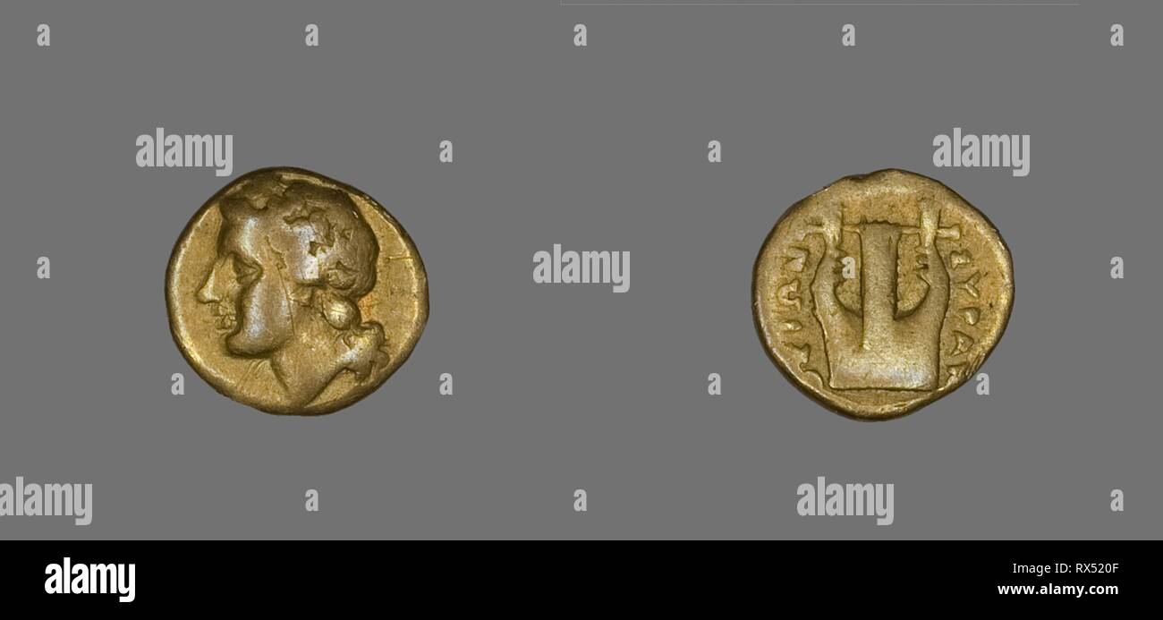 Coin Depicting the God Apollo. Greek. Date: 357 BC-353 BC. Dimensions: Diam. 1.2 cm; 1.72 g. Electrum. Origin: Greece. Museum: The Chicago Art Institute. Author: ANCIENT GREEK. Stock Photo