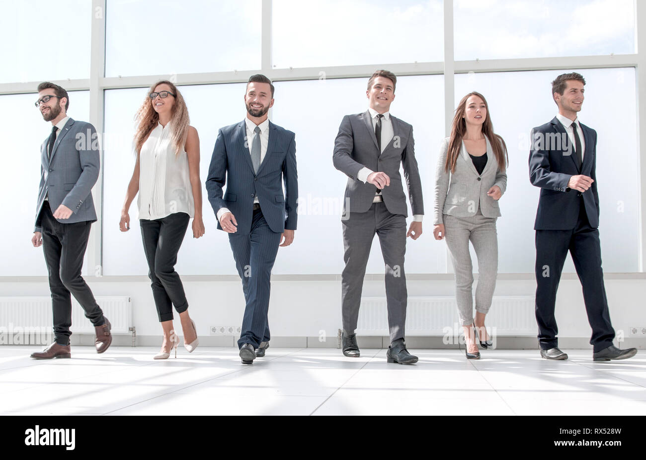 successful business team standing in the office hall Stock Photo - Alamy