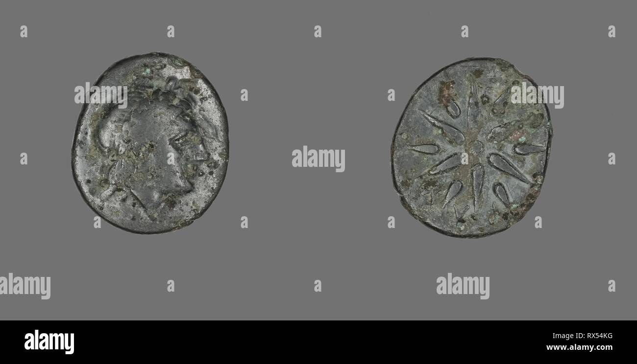 Coin Depicting the God Apollo. Greek. Date: 400 BC-301 BC. Dimensions: Diam. 1.8 cm; 3.08 g. Bronze. Origin: Ancient Greece. Museum: The Chicago Art Institute. Stock Photo