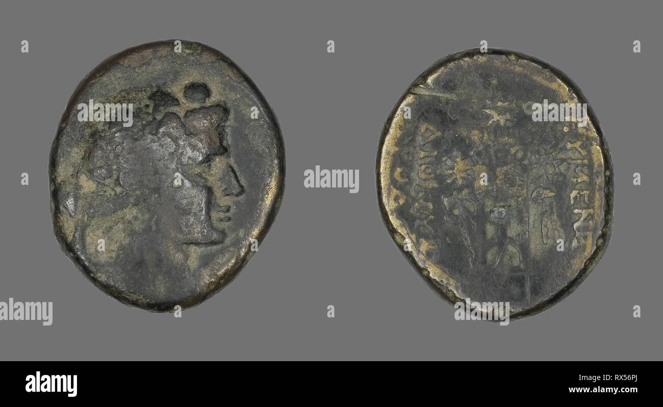 Coin Depicting the God Dionysos. Greek. Date: 133 BC. Dimensions: Diam. 2.6 cm; 11.39 g. Bronze. Origin: Ancient Greece. Museum: The Chicago Art Institute. Stock Photo