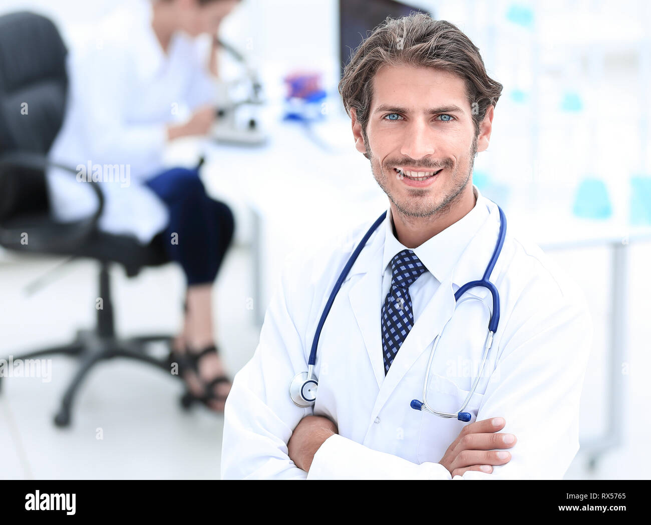 Handsome Male Doctor Smiling With Arms Crossed On Chest Portrait