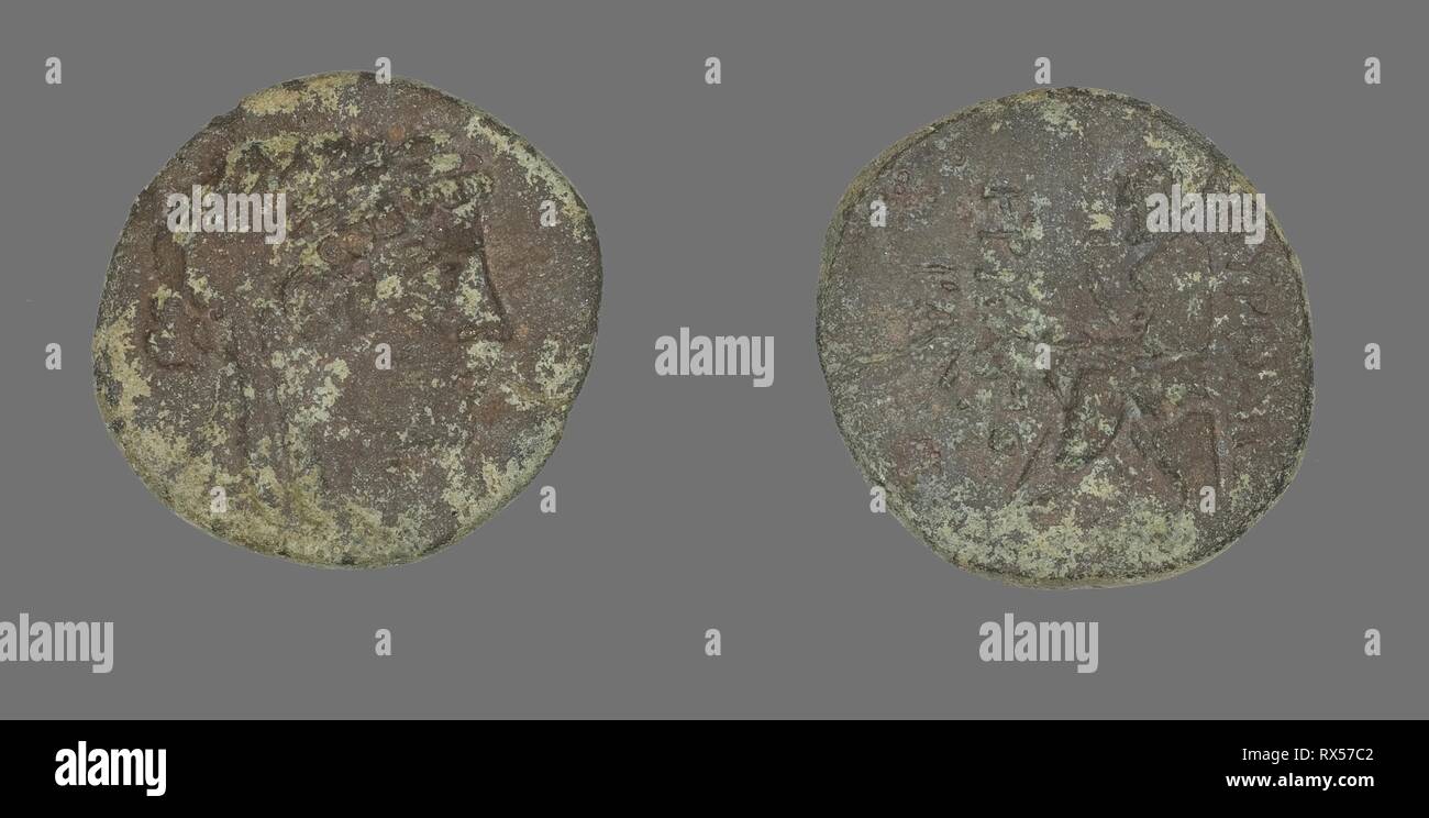 Coin Depicting the God Apollo. Greek. Date: 200 BC-1 BC. Dimensions: Diam. 2.3 cm; 5.77 g. Bronze. Origin: Ancient Greece. Museum: The Chicago Art Institute. Stock Photo