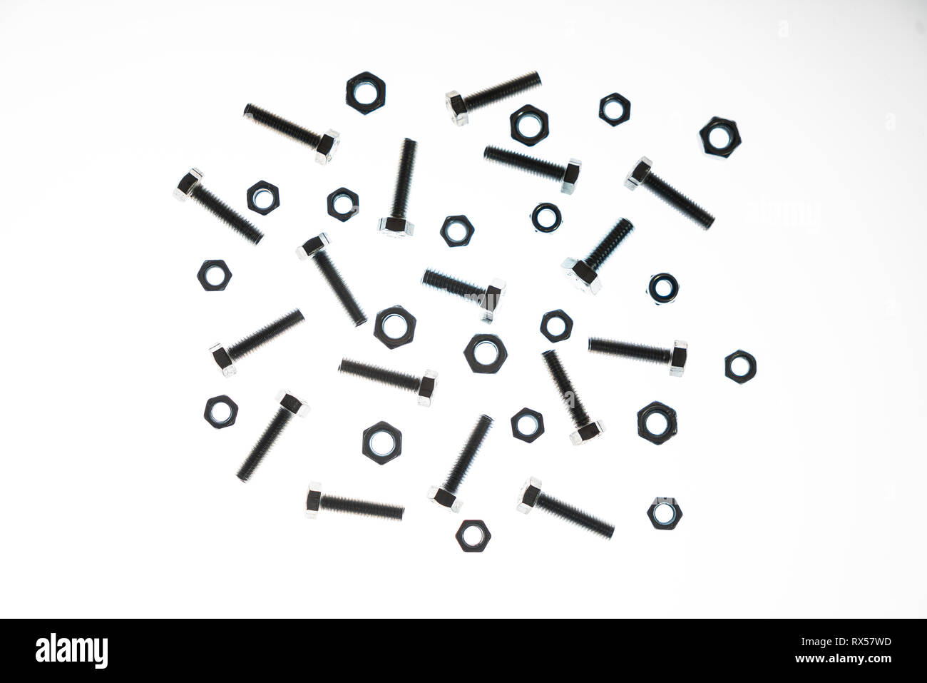 some lock nuts and bolts of various sizes on a white background Stock