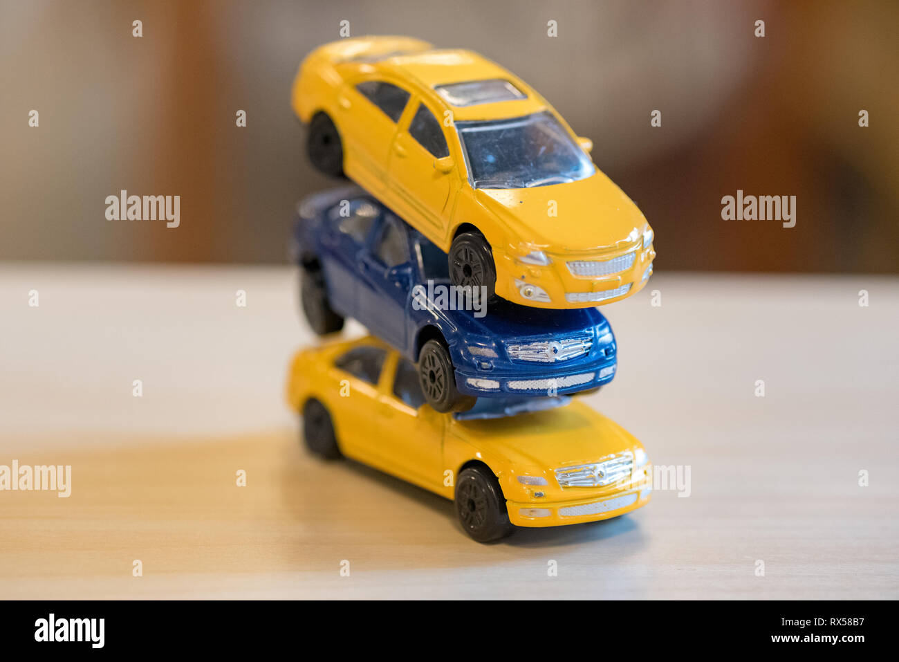 three toy cars in yellow and blue indoors at a preeschool in Sweden Stock Photo
