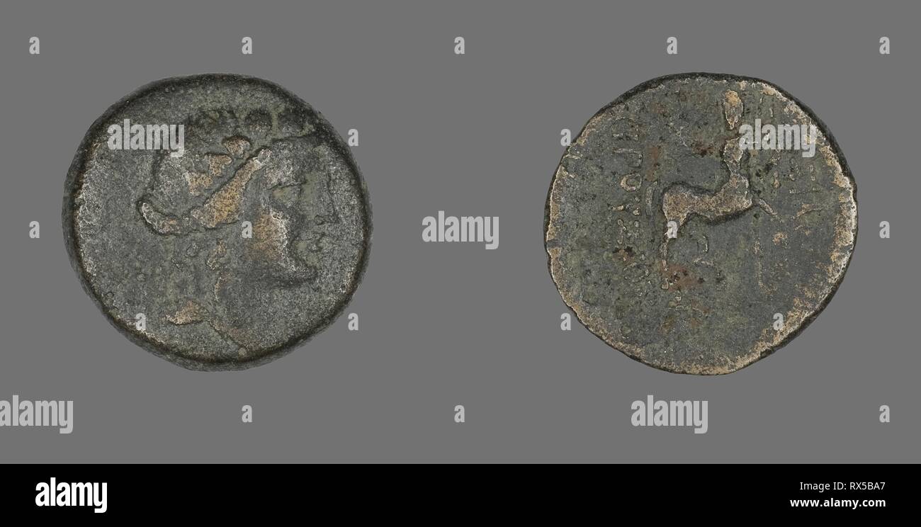 Coin Depicting the God Dionysos. Greek. Date: 183 BC-149 BC. Dimensions: Diam. 2.2 cm; 5.19 g. Bronze. Origin: Ancient Greece. Museum: The Chicago Art Institute. Stock Photo