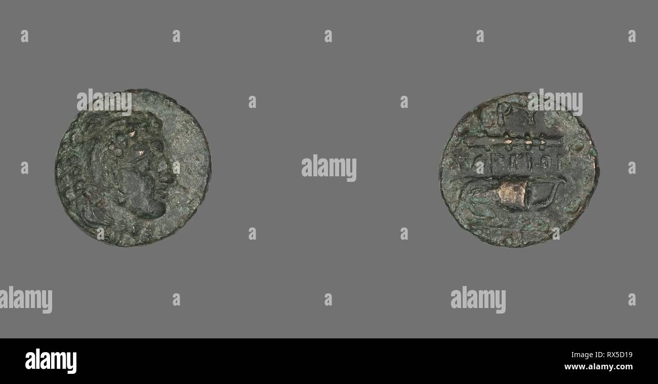 Coin Depicting the Hero Herakles. Greek. Date: 387 BC-300 BC. Dimensions: Diam. 1.3 cm; 1.64 g. Bronze. Origin: Ancient Greece. Museum: The Chicago Art Institute. Stock Photo
