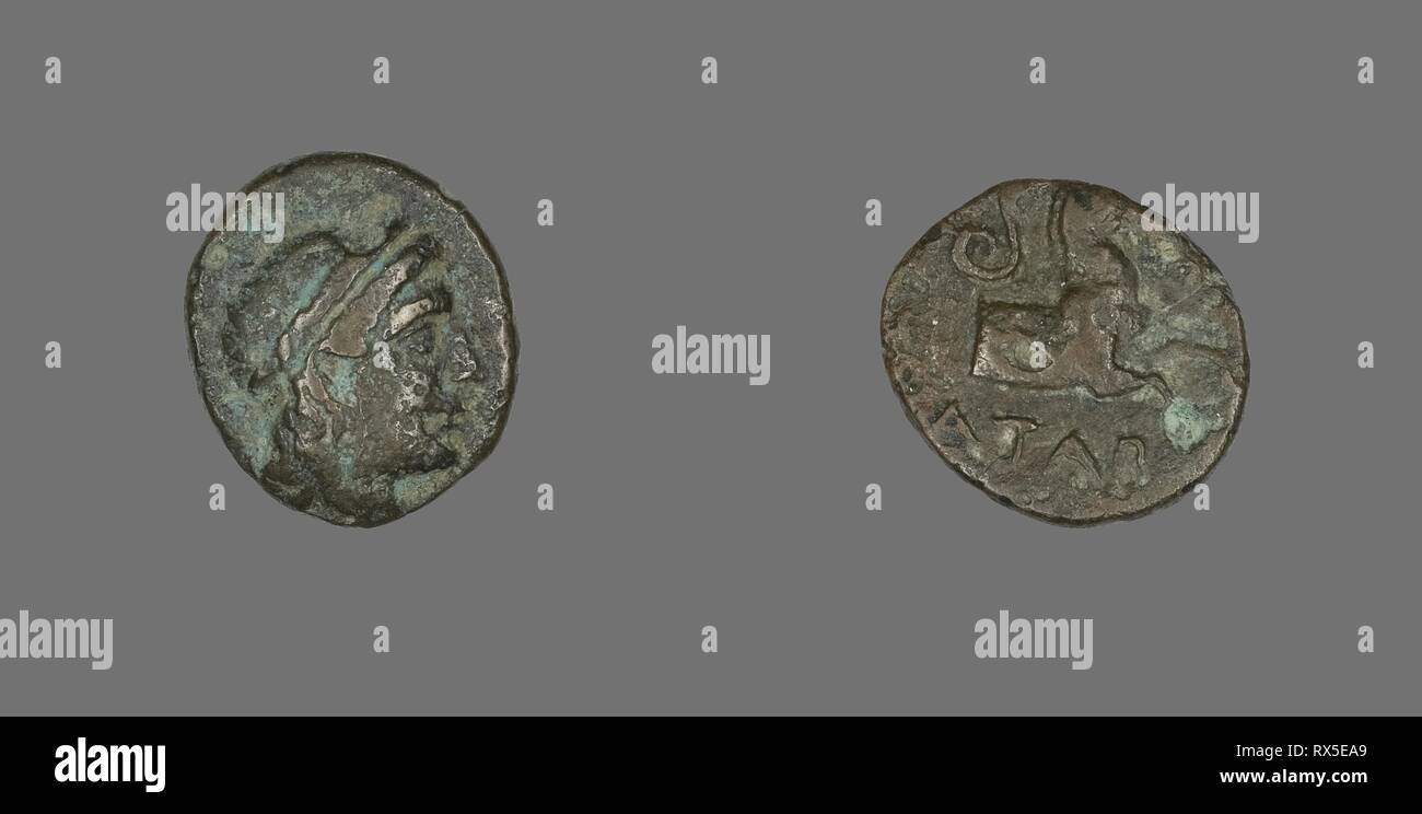 Coin Depicting the God Apollo. Greek. Date: 300 BC-201 BC. Dimensions: Diam. 1.7 cm; 3.07 g. Bronze. Origin: Ancient Greece. Museum: The Chicago Art Institute. Stock Photo