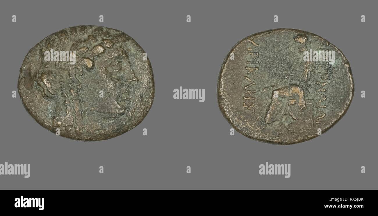 Coin Depicting the God Apollo. Greek. Date: 200 BC-1 BC. Dimensions: Diam. 2.3 cm; 7.64 g. Bronze. Origin: Ancient Greece. Museum: The Chicago Art Institute. Stock Photo