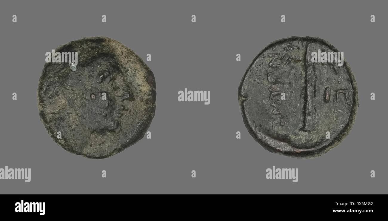 Coin Depicting the God Apollo. Greek. Date: 200 BC-1 BC. Dimensions: Diam. 1.2 cm; 1.33 g. Bronze. Origin: Ancient Greece. Museum: The Chicago Art Institute. Stock Photo