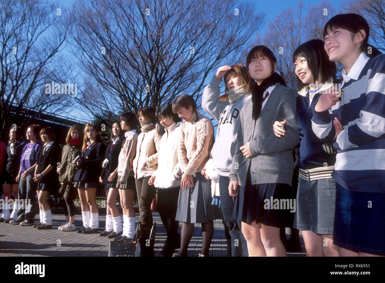 Japanese schoolgirls await the arrival of band, Yoyogi-koen Harajuku, Tokyo, December 2001. Stock Photo