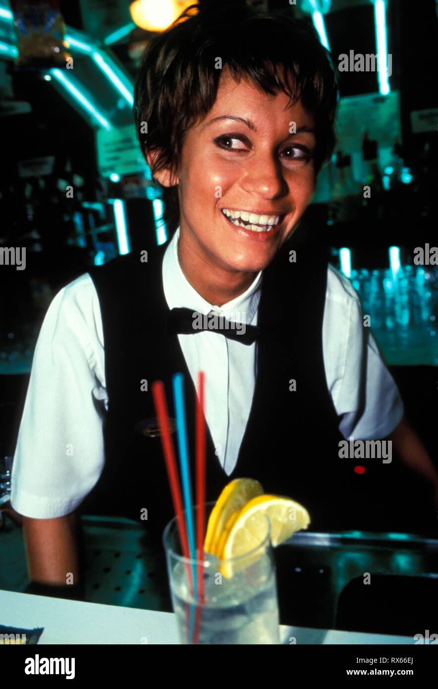 Female bar staff smartly dressed, waistcoat and bow tie, 1990's Stock