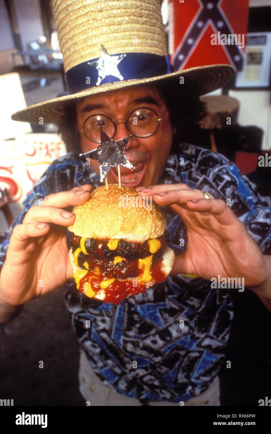Fast Food, a man eating a double burger Stock Photo