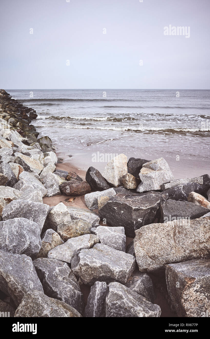 Rocky beach on a cloudy day, color toning applied Stock Photo Alamy