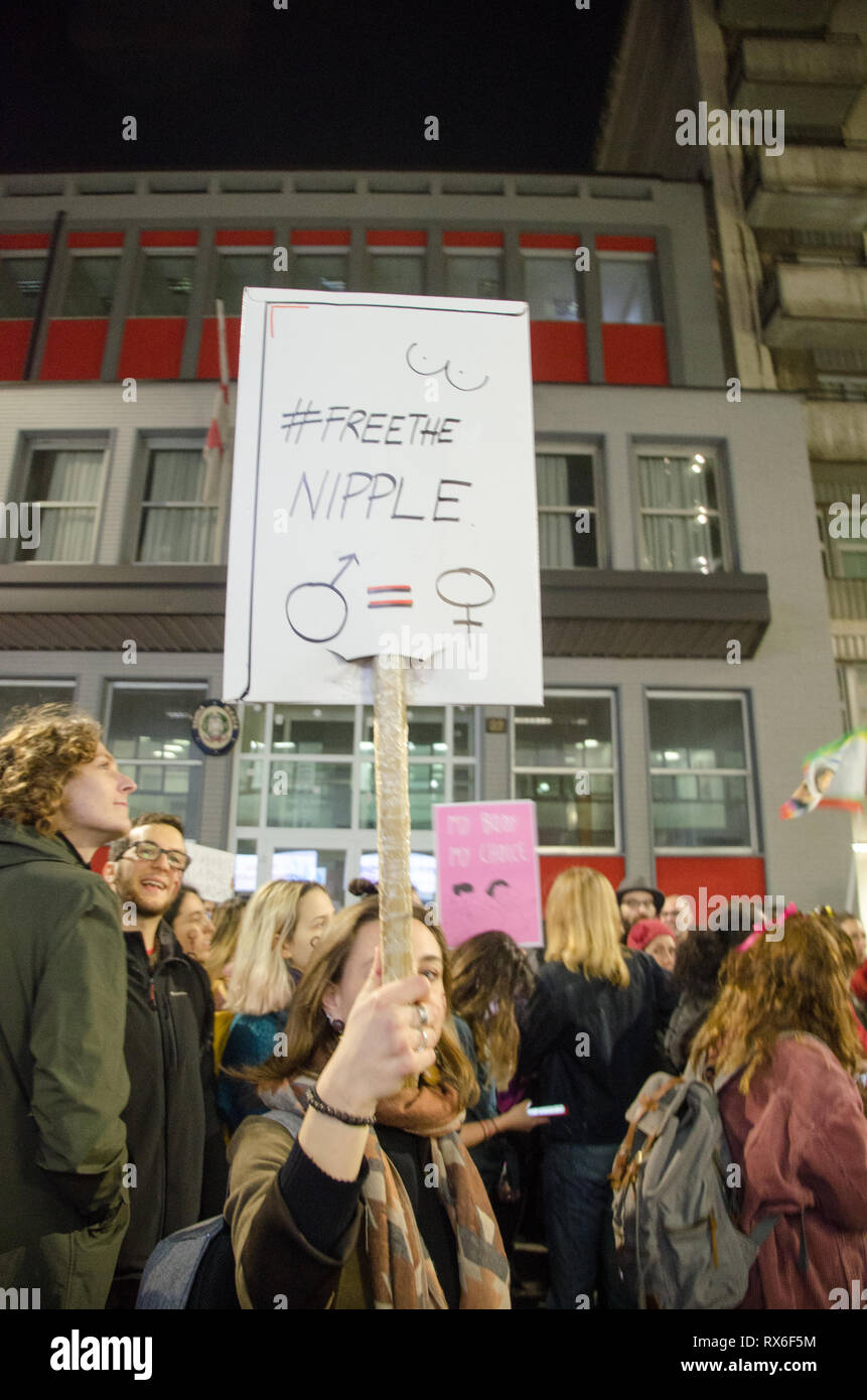 Milan, Italy. 8th Mar 2019. A woman holds a sign that reads Free Nipples during International Women's Day In Milano Stock Photo