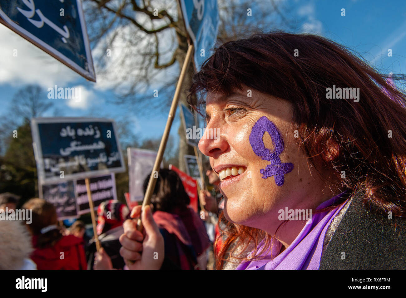 Brussels, North Brabant, Belgium. 8th Mar, 2019. A woman is seen wearing  the female symbol painting in her face during the protest.On the 40th  anniversary of the 5-days women's uprising against "compulsory