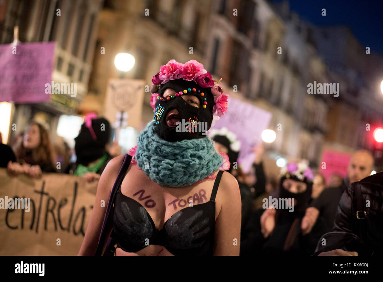 A protester with her face masked and wearing a bra is seen during