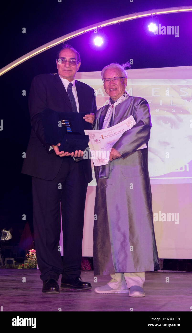 Sharm El Sheikh, Egypt. 9th Mar, 2019. Chinese renowned filmmaker Xie Fei (R), head juror at the Sharm el-Sheikh Asian Film Festival (SAFF), is honored by a certificate of appreciation at the closing ceremony of the film festival in Sharm el-Sheikh, Egypt, March 8, 2019. The film festival closed on Friday with a feature movie from Afghanistan, Rona Azim's Mother, winning the best prize. Credit: Wu Huiwo/Xinhua/Alamy Live News Stock Photo