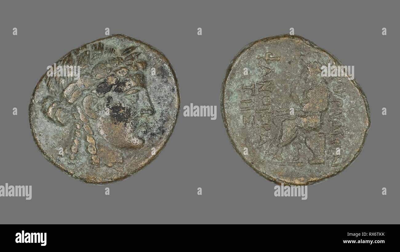 Coin Depicting the God Apollo. Greek. Date: 200 BC-1 BC. Dimensions: Diam. 2.4 cm; 8.72 g. Bronze. Origin: Ancient Greece. Museum: The Chicago Art Institute. Stock Photo