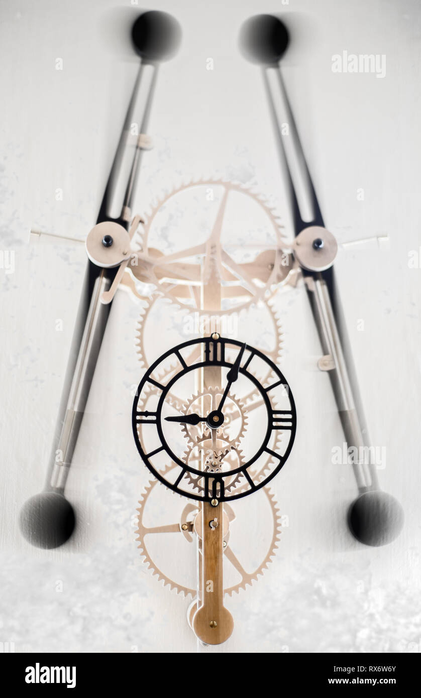 Clock with moving parts and gears showing and arms swinging Stock Photo