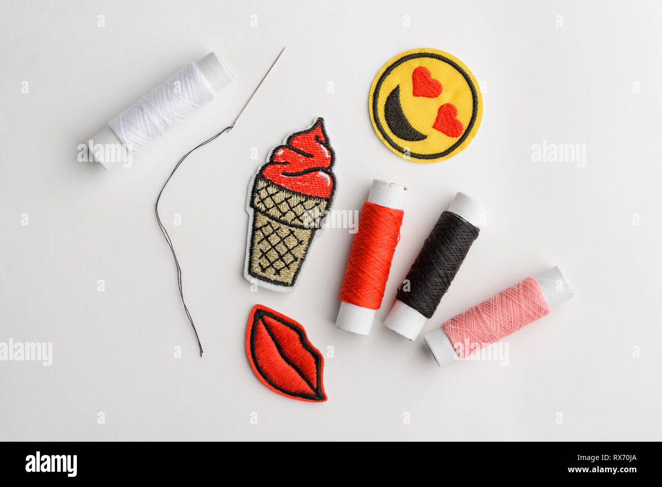 Embroidered patches, needle and thread Stock Photo