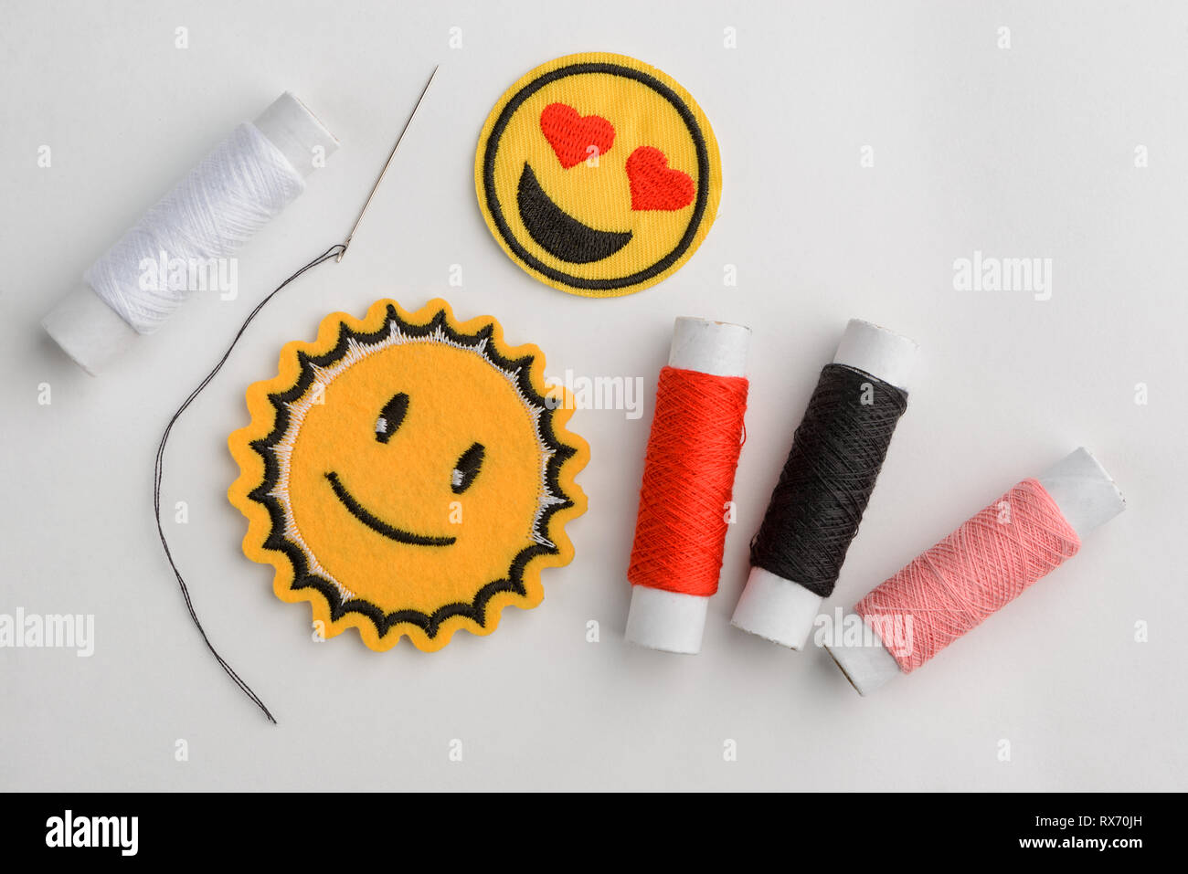 Emoji embroidered patches and thread Stock Photo