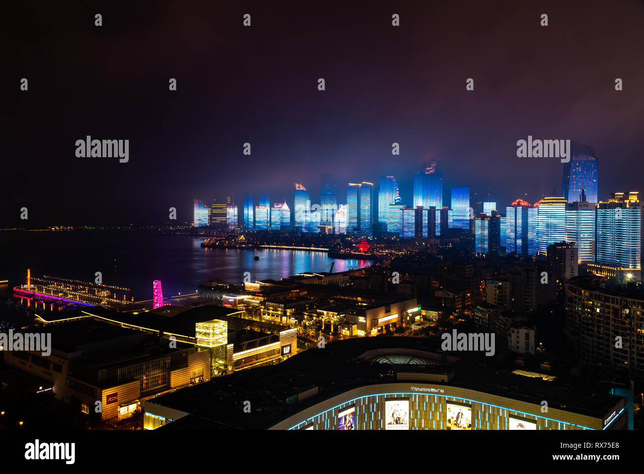 June 2018 - Qingdao, China - The new lightshow of Qingdao skyline created for the SCO summit between China and Russia of June 2018 behind 4th may squa Stock Photo