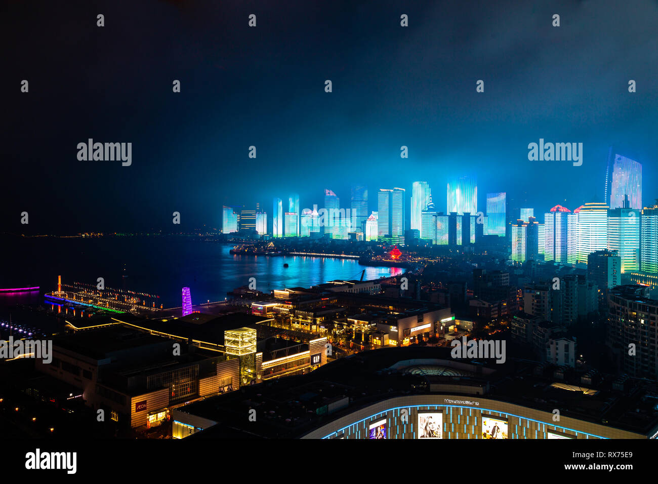 June 2018 - Qingdao, China - The new lightshow of Qingdao skyline created for the SCO summit between China and Russia of June 2018 behind 4th may squa Stock Photo