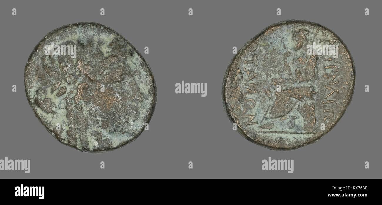 Coin Depicting the God Apollo. Greek. Date: 200 BC-101 BC. Dimensions: Diam. 2.3 cm; 7.69 g. Bronze. Origin: Ancient Greece. Museum: The Chicago Art Institute. Stock Photo