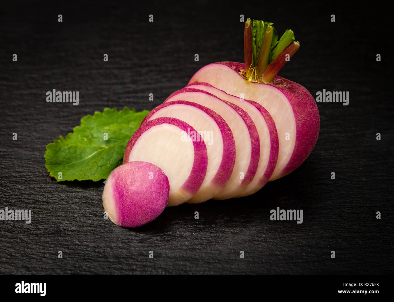 close-up of a red turnip sliced over a black background Stock Photo