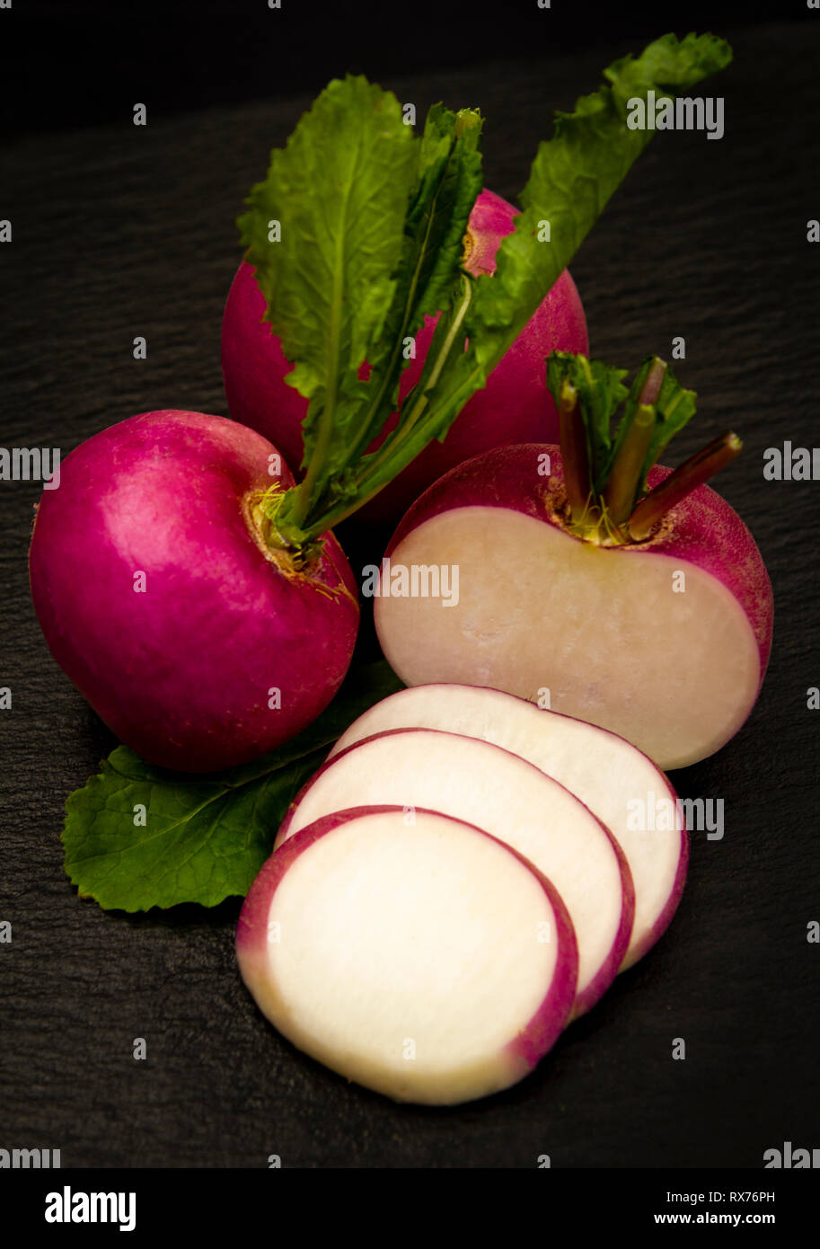 close-up of a red turnip sliced over a black background Stock Photo