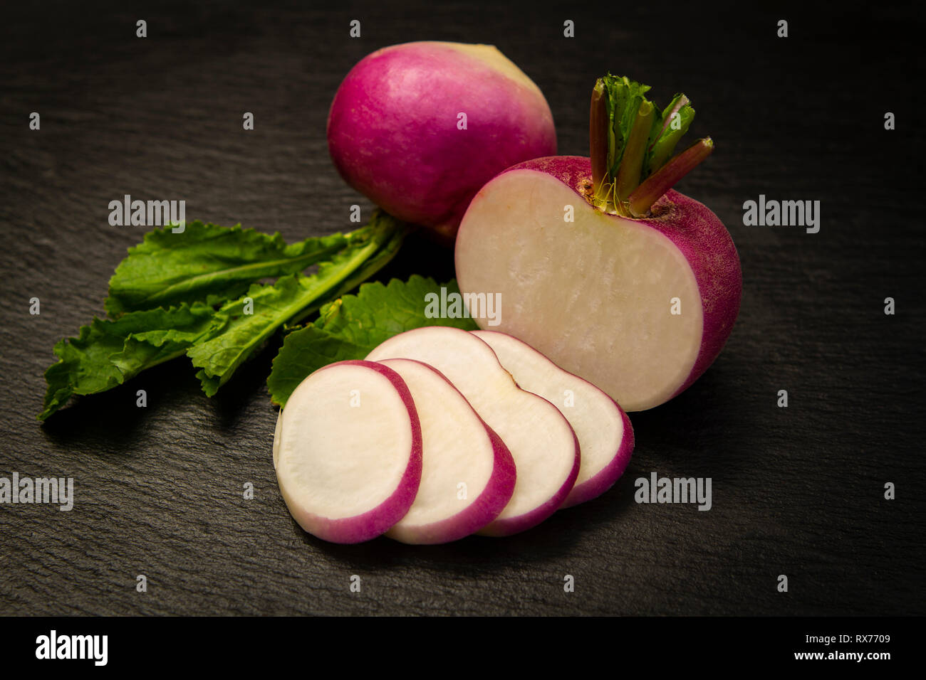 close-up of a red turnips sliced over a black background Stock Photo