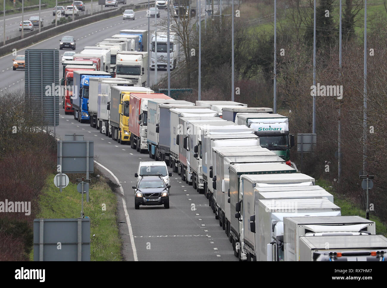 Lorries queue to enter the Eurotunnel site in Folkestone, Kent, as industrial action in France continues. Stock Photo