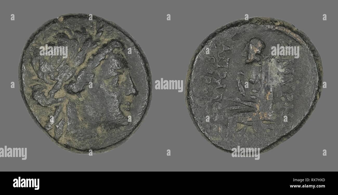 Coin Depicting the God Apollo. Greek. Date: 200 BC-1 BC. Dimensions: Diam. 2.2 cm; 7.56 g. Bronze. Origin: Ancient Greece. Museum: The Chicago Art Institute. Stock Photo