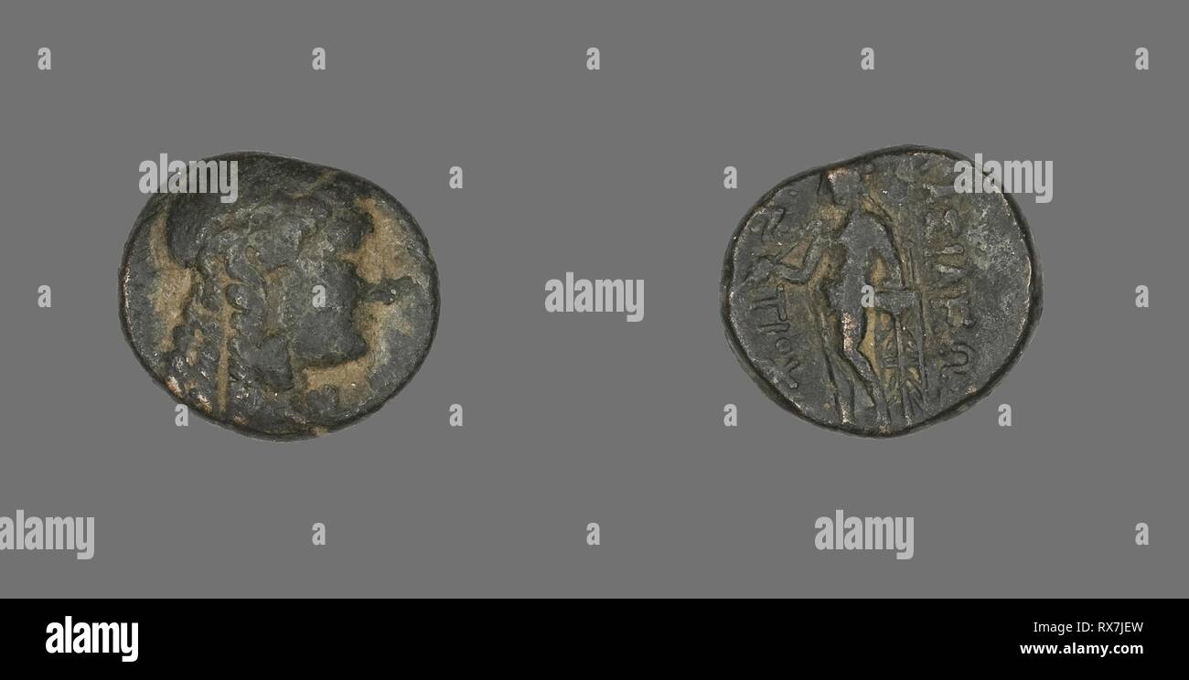 Coin Depicting the God Apollo. Greek. Date: 222 BC-187 BC. Dimensions: Diam. 1.7 cm; 4.46 g. Bronze. Origin: Ancient Greece. Museum: The Chicago Art Institute. Stock Photo