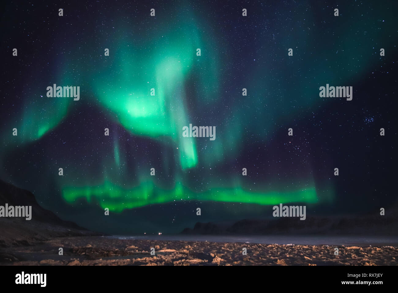 Aurora Borealis viewed from the small Arctic town of Pangnirtung over the frozen Cumberland Sound. Stock Photo