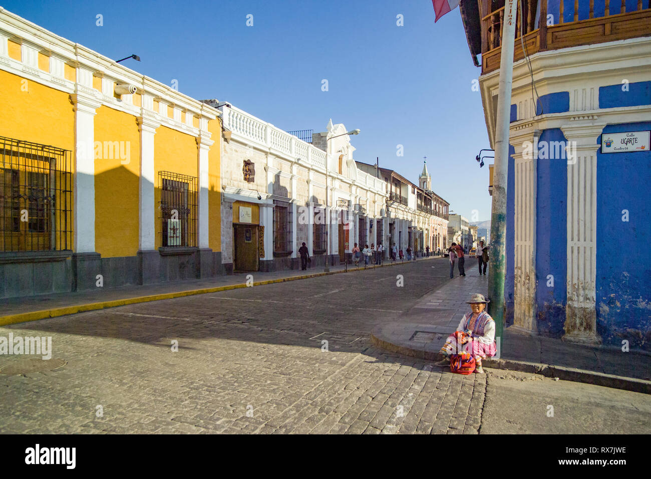 AREQUIPA, PERU. 04-08-2008. local woman sitting on the corner of a street in the historic center Stock Photo