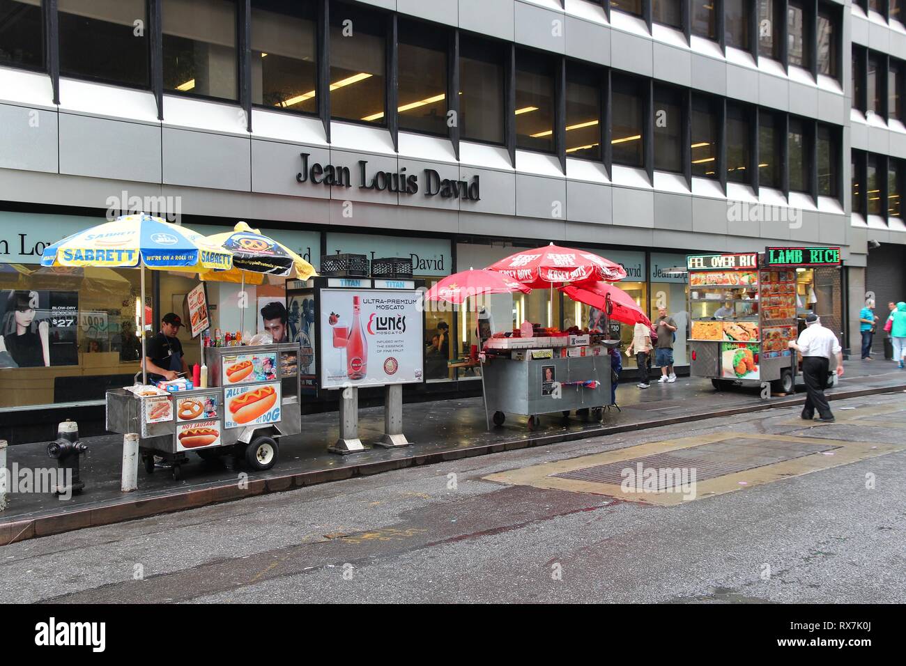 NEW YORK, USA - JULY 1, 2013: Vendors sell hot dogs and lamb rice in New York. It is estimated that Americans eat some 20 billion hot dogs a year (NHD Stock Photo