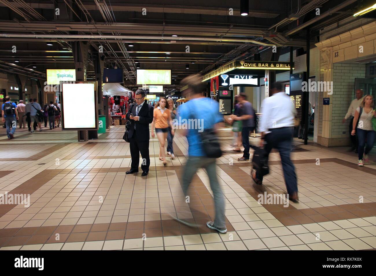 CHICAGO, USA - JUNE 26, 2013: Passengers hurry at Ogilvie Transportation Center in Chicago. OTC is an important train station opened in 1912. Stock Photo