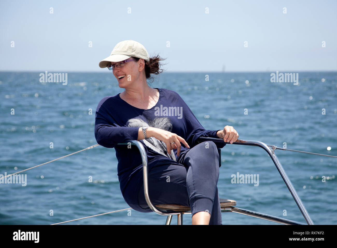 Woman On Deck Seat on Catamaran at Sea in Table Bay, Cape Town, South Africa Stock Photo