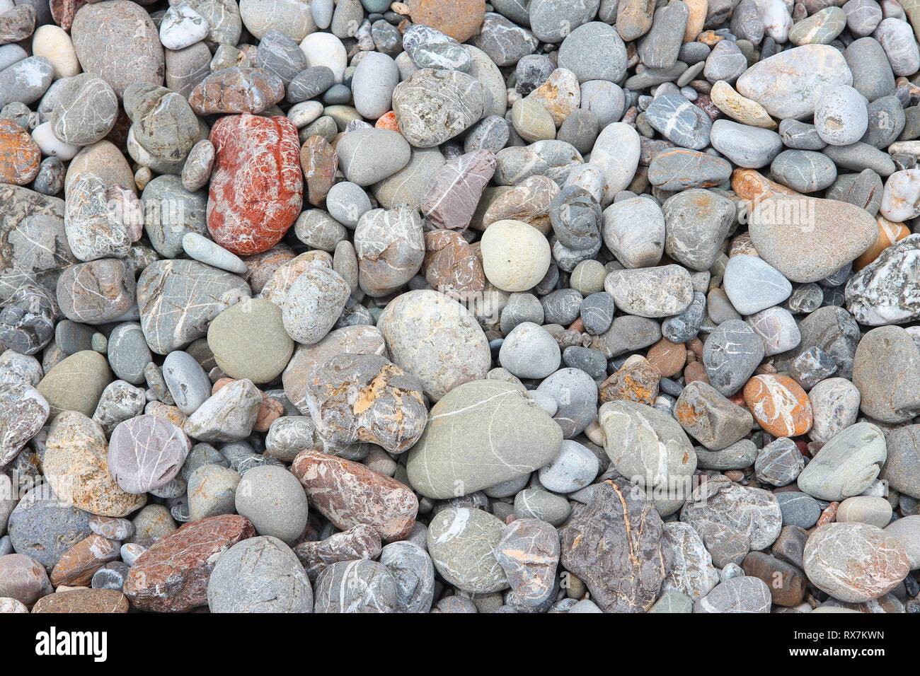 Pebbly beach background from Crete, Greece. Shingle beach. Stock Photo