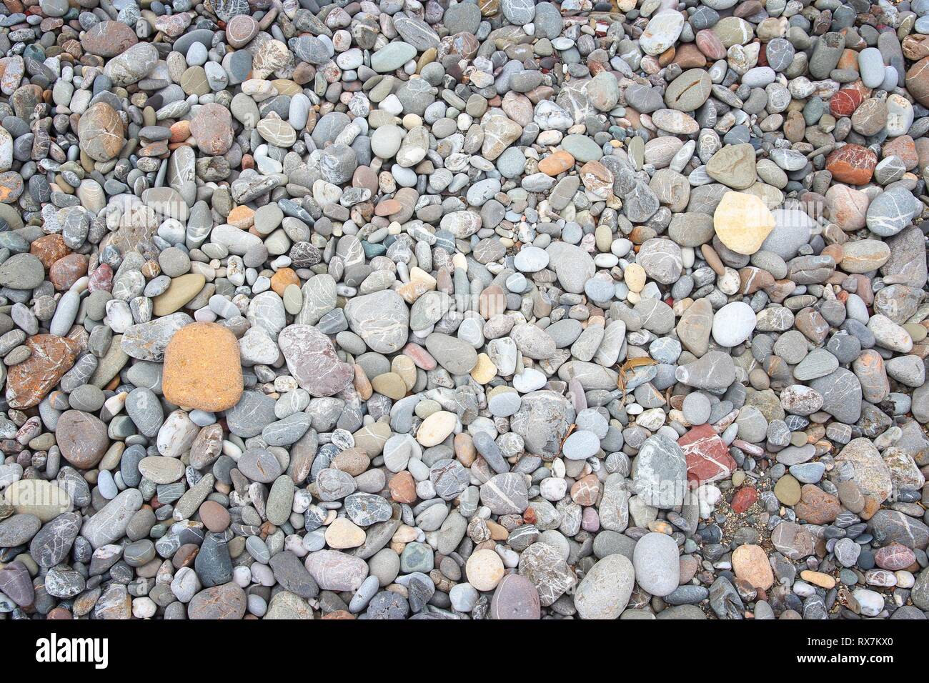 Pebbly beach background from Crete, Greece. Shingle beach. Stock Photo