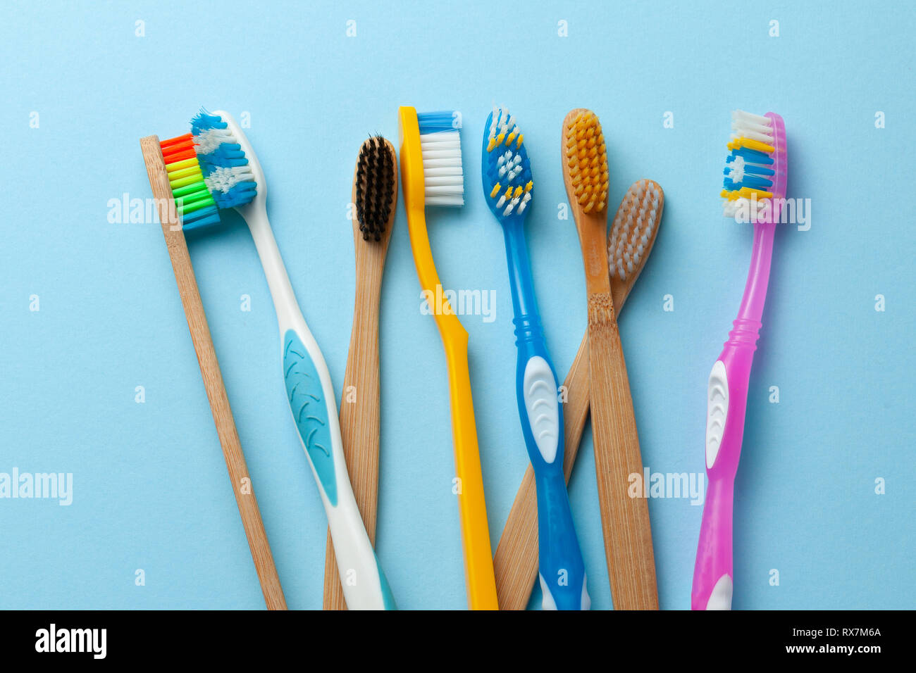 Colored toothbrushes on blue background Stock Photo