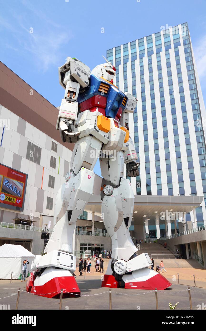 TOKYO, JAPAN MAY 11, 2012 People visit Gundam robot replica in Odaiba,Tokyo. The sculpture is