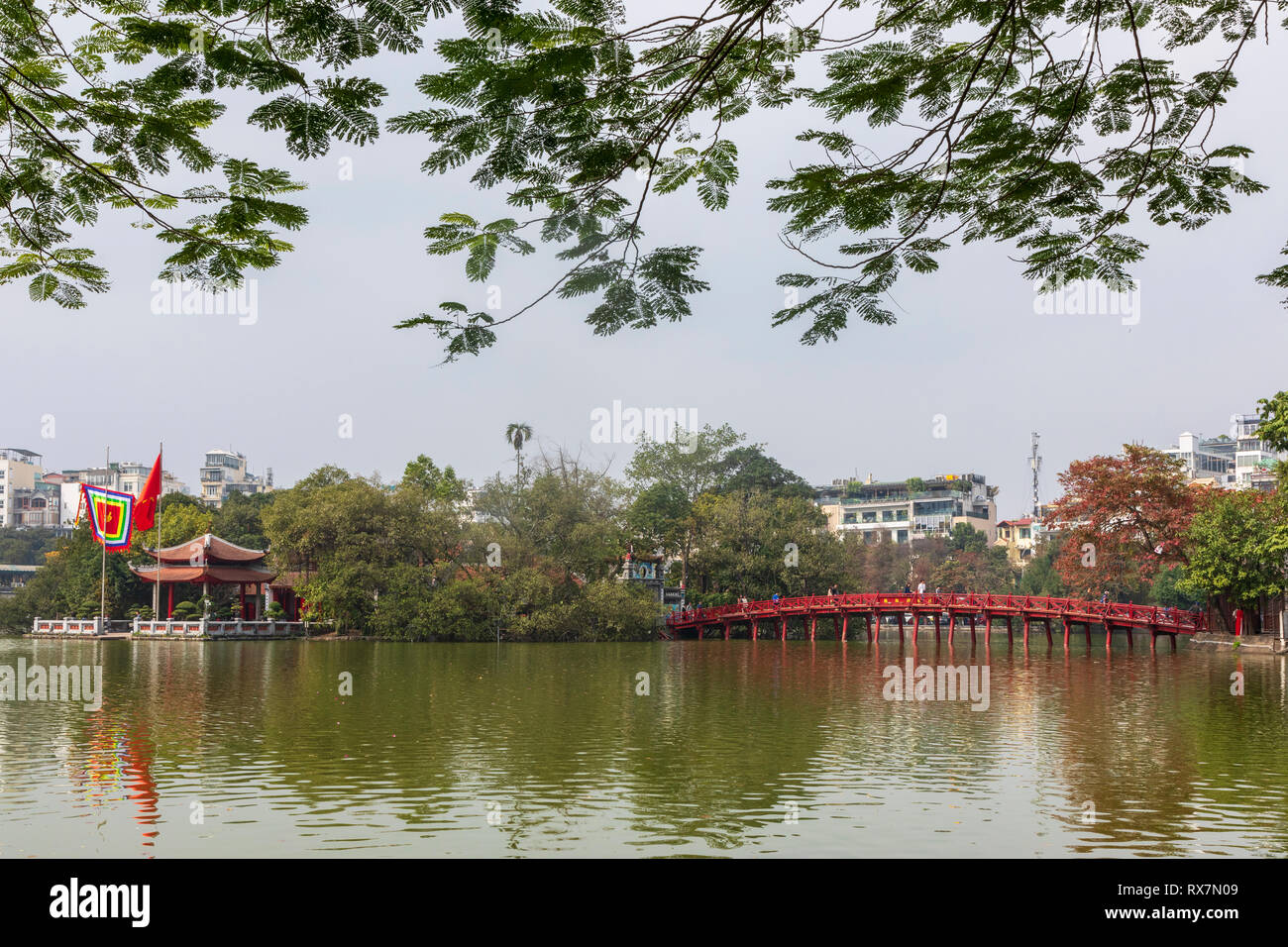 Wooden Huc Bridge also known as the Bridge off the Rising Sun because of its colour, crosses Ho Hoan Kiem lake from the Old Quarter to the Temple of t Stock Photo