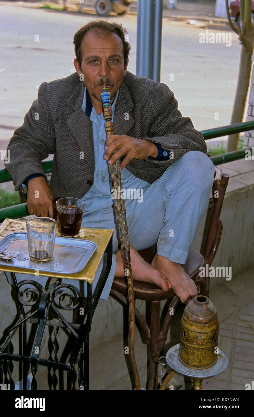 Arab man smoking a traditional Arabian shisha. Saqqara (Egypt). Stock Photo