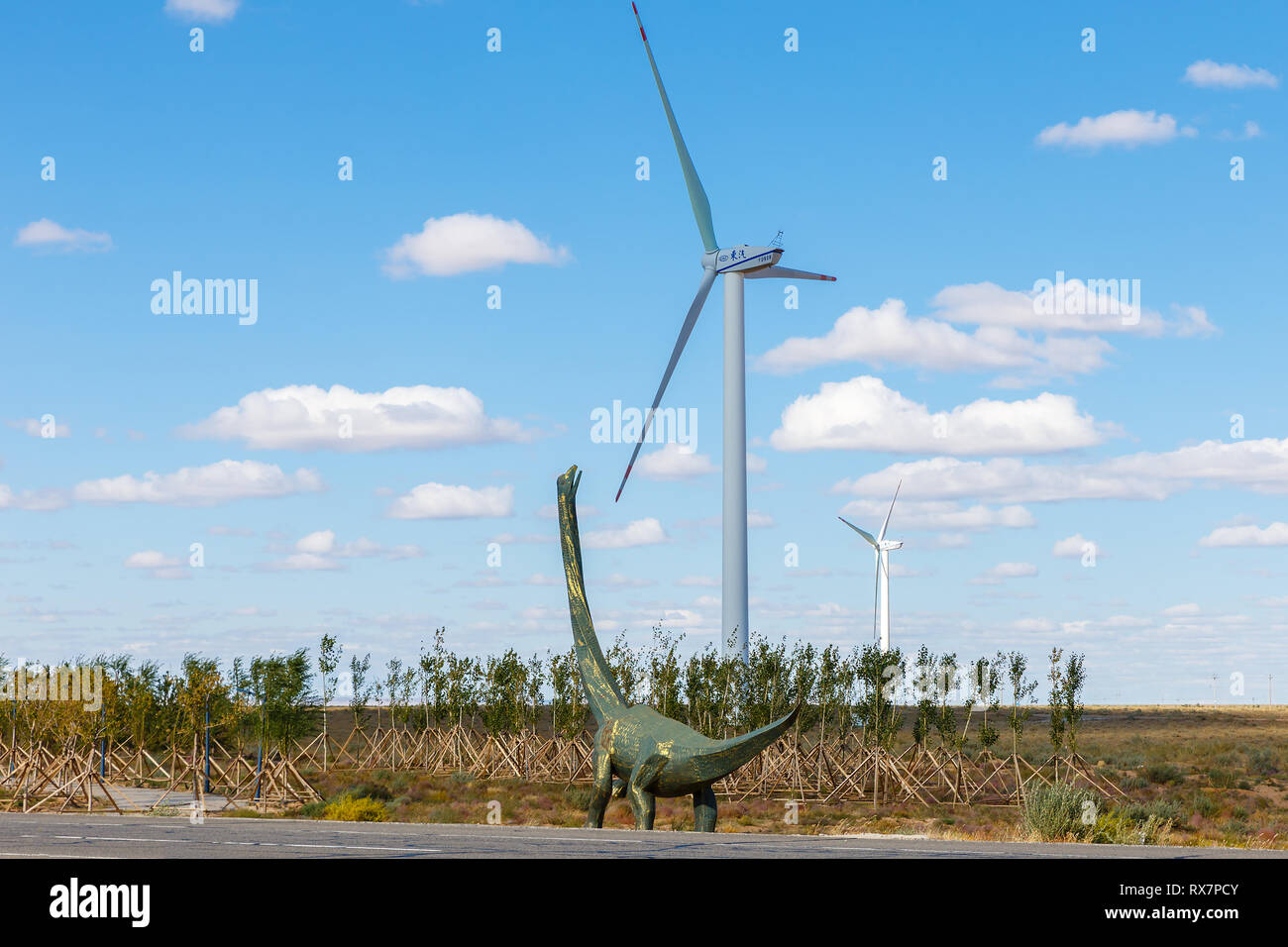 Erenhot, China - September 23, 2018: Dinosaur metal sculpture. Dinosaur  looks at the wind generator in the steppe Stock Photo - Alamy
