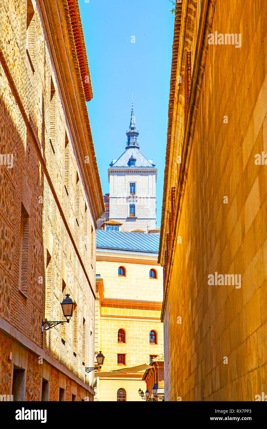 Old street and one of  towers of Alcasar in Toledo, Spain Stock Photo