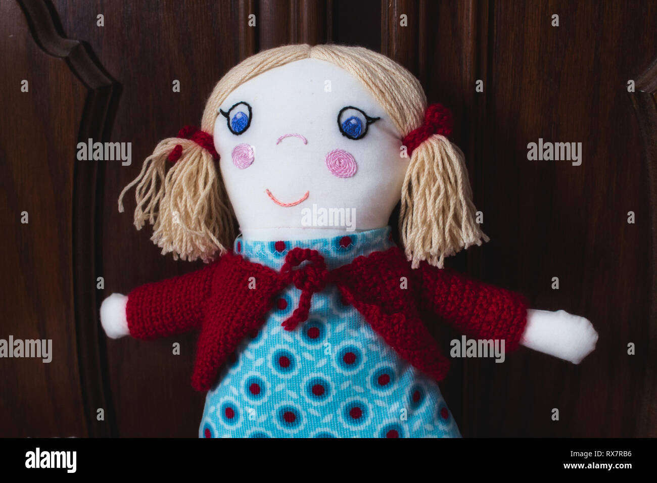 Closeup of knitted stuffed rag doll soft toy for a child Stock Photo