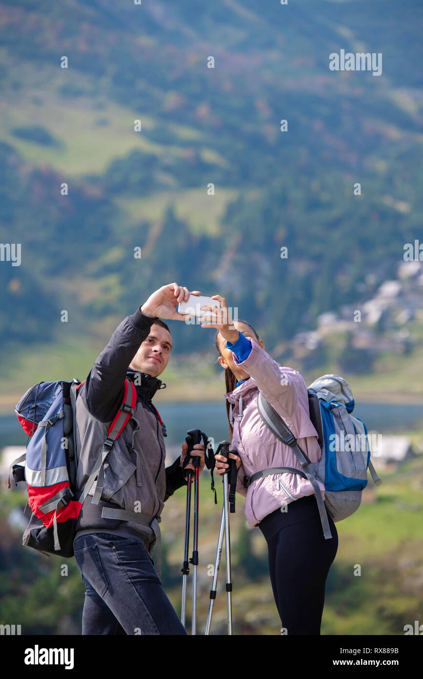 Two hikers taking selfie on top of the mountain Stock Photo - Alamy
